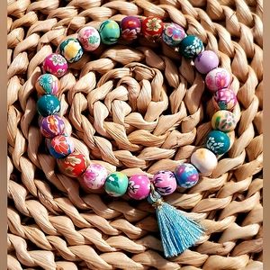 Handmade 8mm polymer clay bead flower print stretch bracelet w/ tassel.